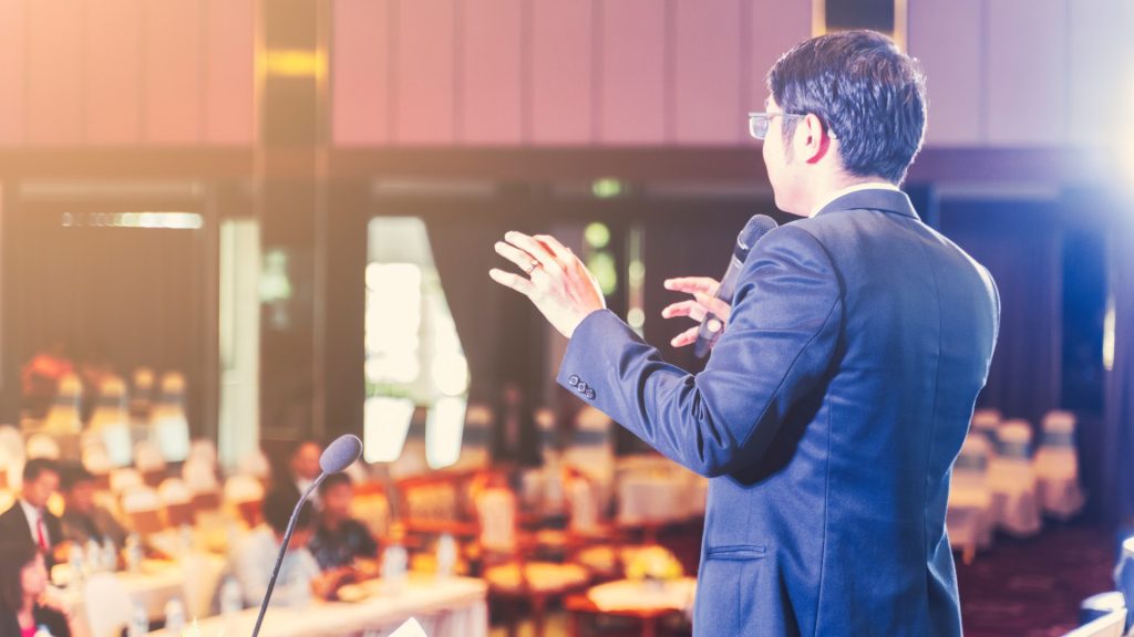 Speaker presenting at a Magento seminar